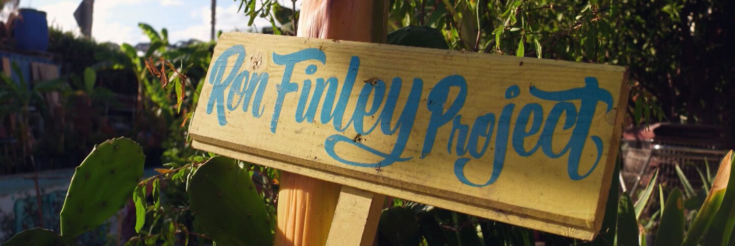 Ron Finley Project sign inside his garden. | Still from "Broken Bread"