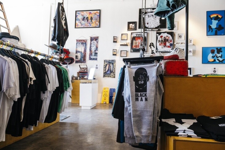 Inside of a retail store with racks of clothes