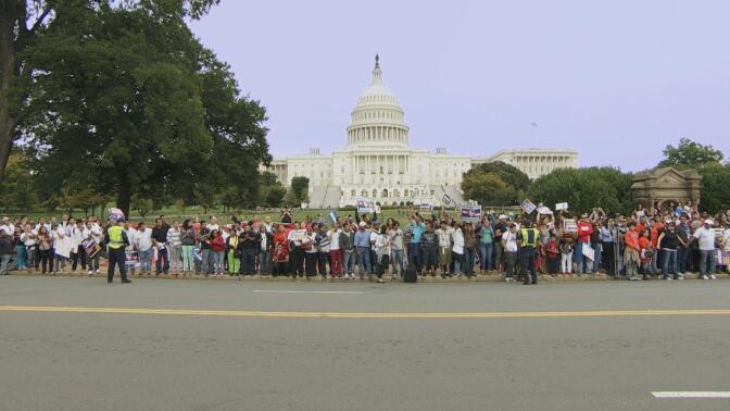 A long line of people petition outside the White House.