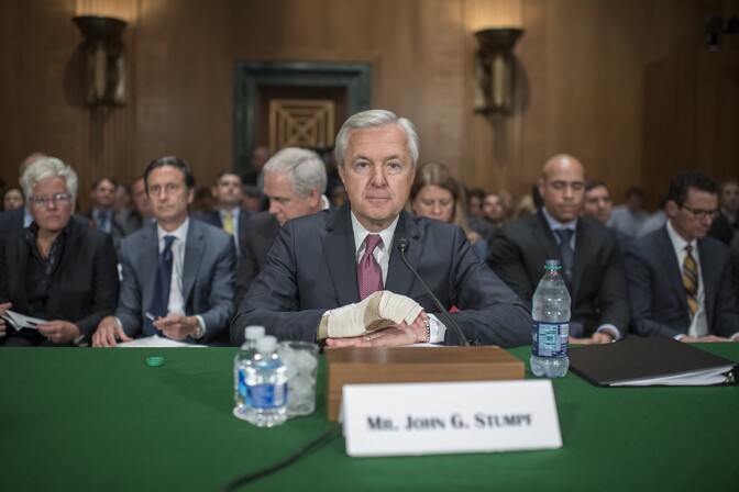 Wells Fargo CEO John Stumpf, center, prepares to testify at a Senate Banking, Housing, and Urban Affairs hearing in Dirksen Building, September 20, 2016, on the company's unauthorized accounts opened under customers' names. | Getty Images