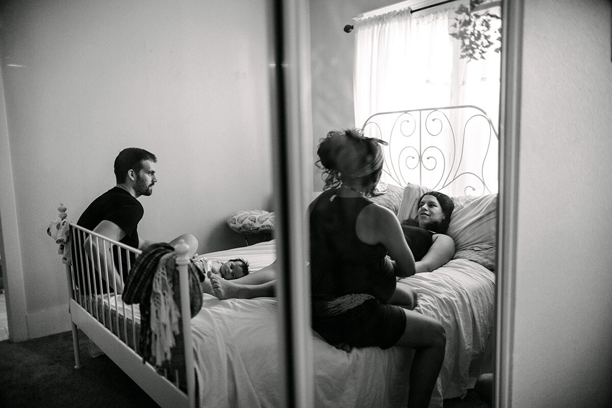 Panquetzani, a postpartum doula, sits with her clients and their newborn baby during their last session. | Samanta Helou Hernandez