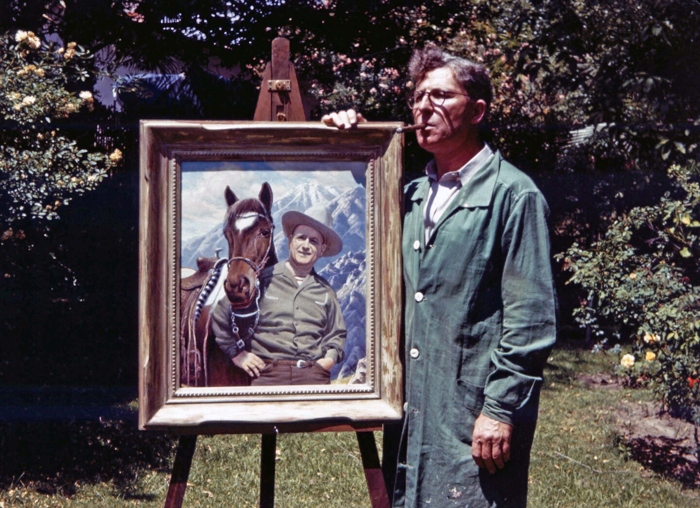 Paul Grimm stands on the side of his painting of Harry Bennett and his horse Sonny.