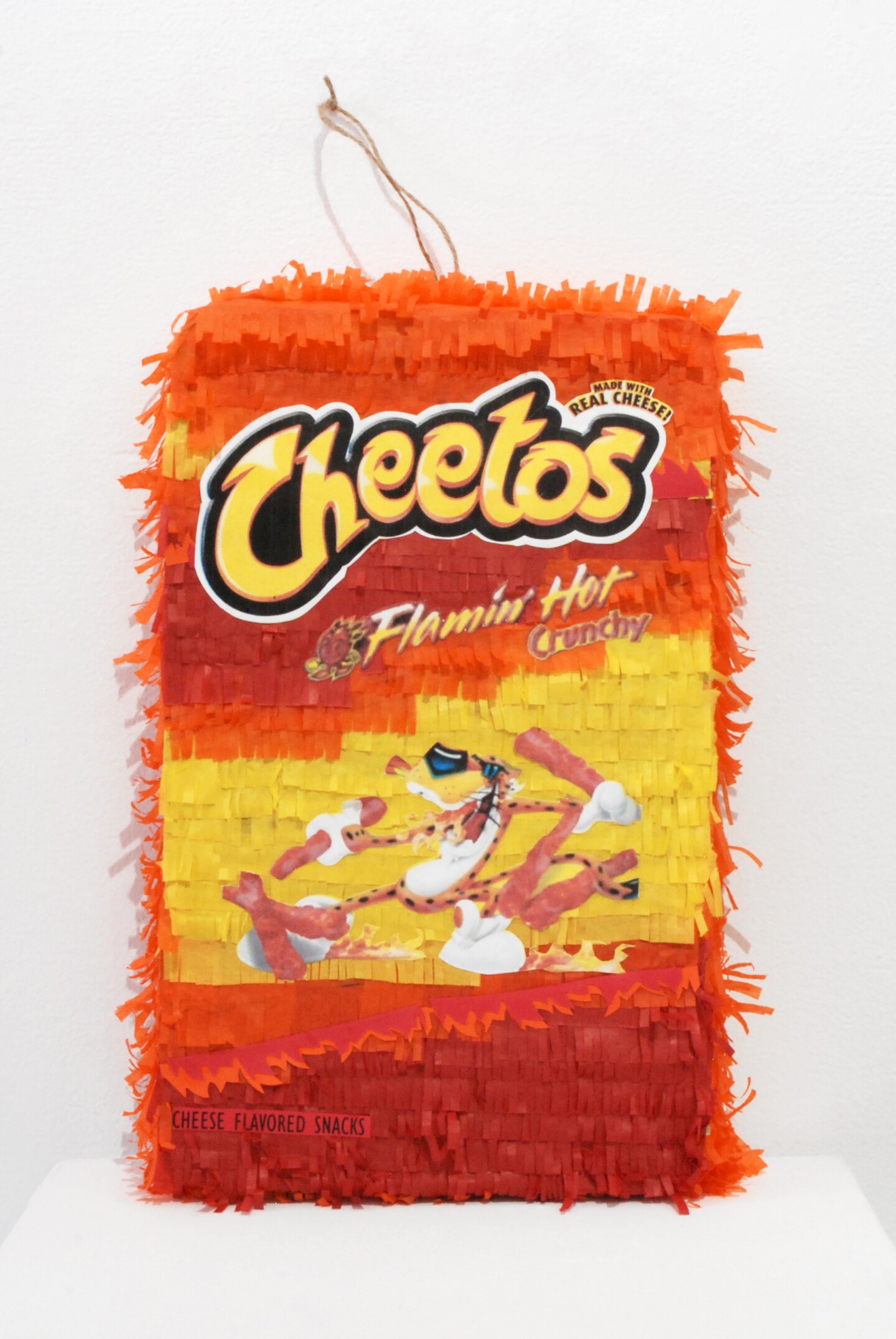 A piñata shaped like a Cheetos bag