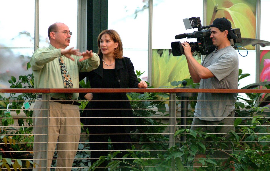Val Zavala Outside with a Camera Operator and an Interview Subject