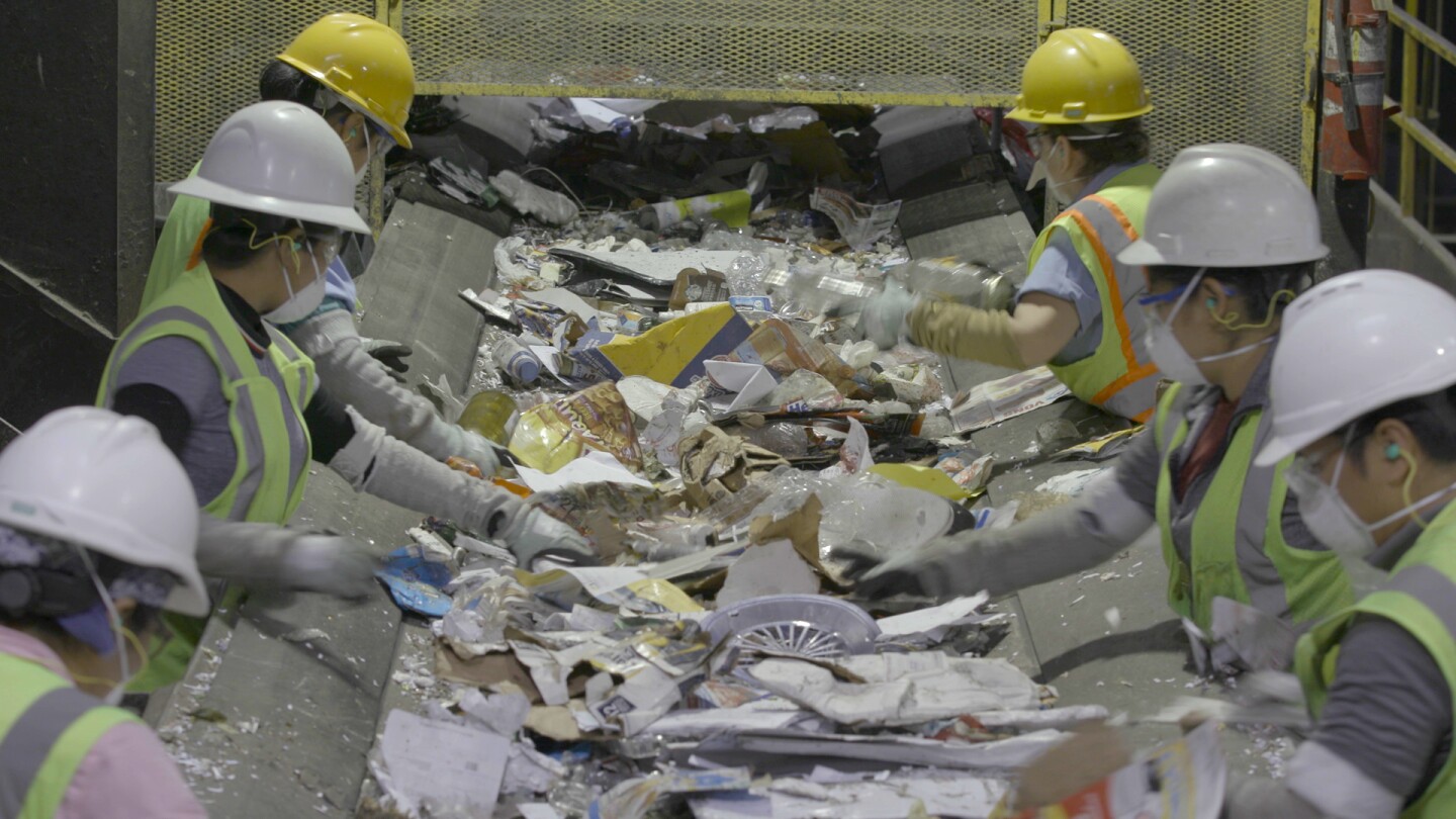 Recycling center employees sorting through materials | Still from SoCal Connected episode, "Life in Plastic: California's Recycling Woes"