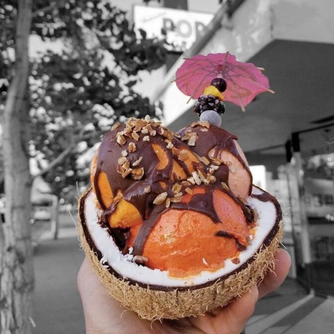 Lucuma, mamey, and pink guava ice cream in a coconut shell bowl | Courtesy of Helados Pops