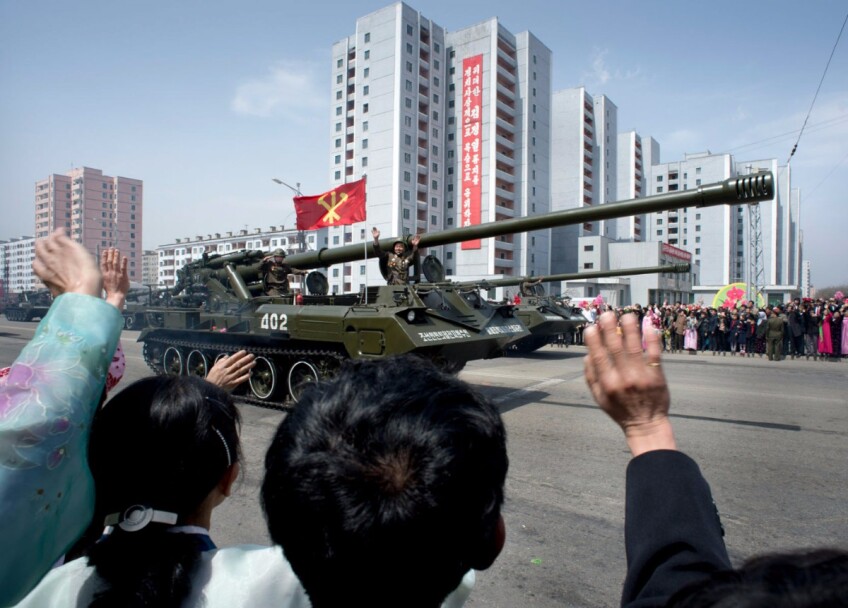 North Koreans wave to soldiers during a massive military parade celebrating the 100th anniversary of the birth of the country's founder Kim Il Sung. Pyongyang, North Korea | Mark Edward Harris