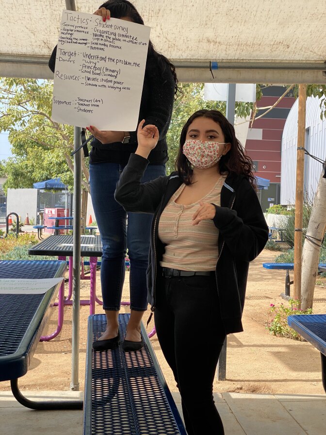 Zambrano-Sanchez and another student holding a sign at school as part of their organizing work with the ACLU Youth Liberty Squad.
