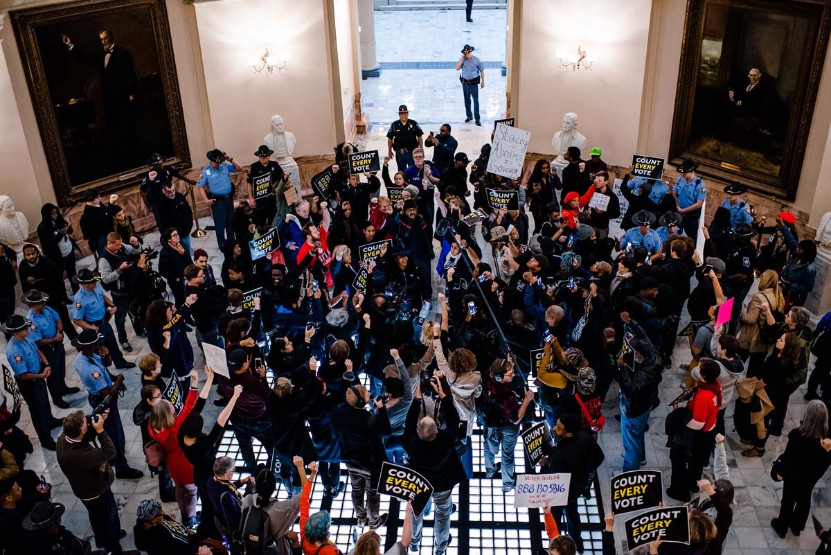 A crowd gathers in the rotunda of the Georgia State Capitol for the Count Every Vote protest in Atlanta, in 2018. | Kevin Lowery
