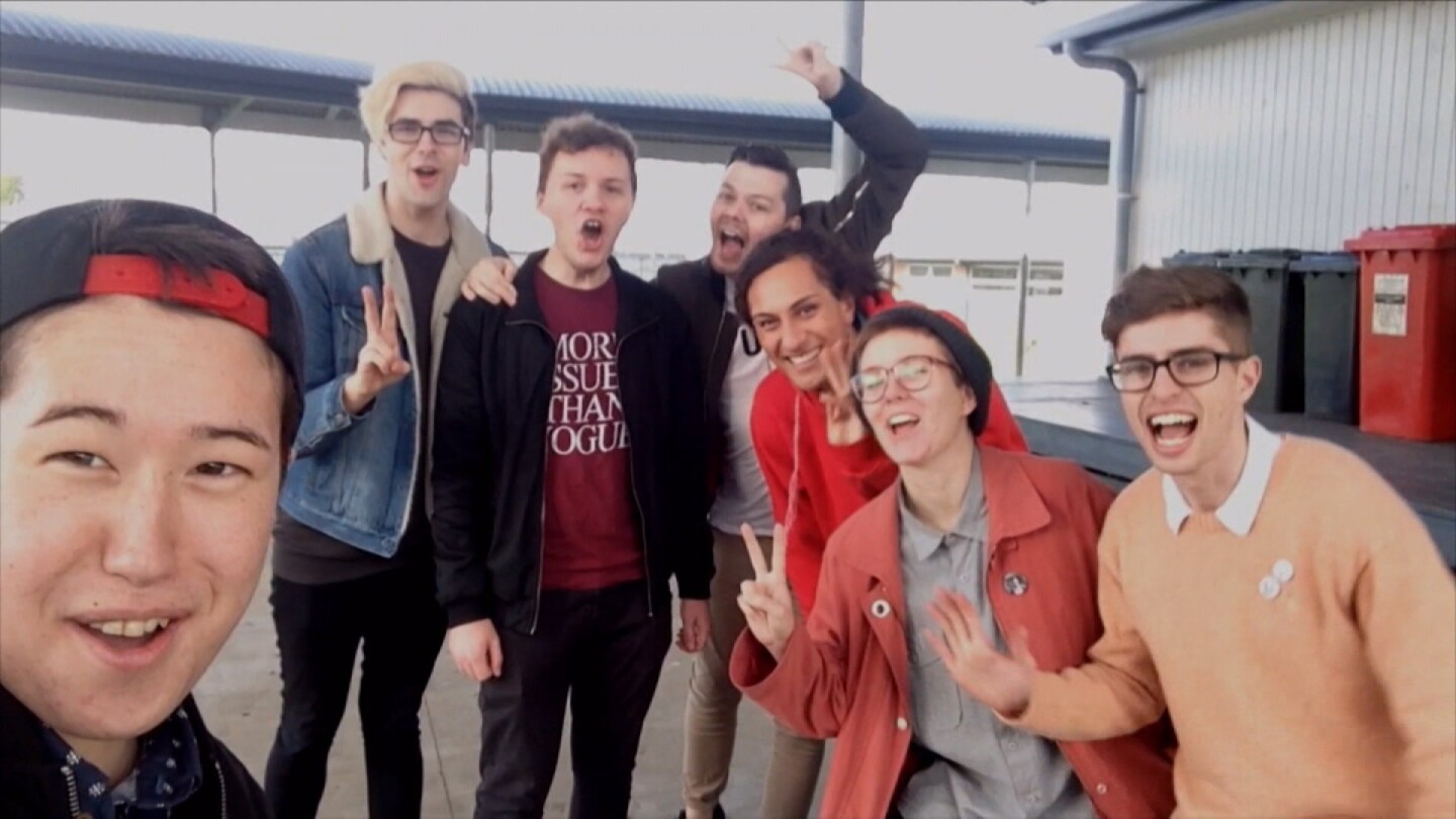 Quinn Fyer takes a selfie with a group of friends. | Still from "Both Worlds"