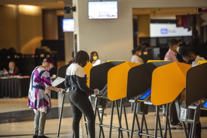 Voters cast their ballots at the vote center inside Staples Center. | Chava Sanchez/LAist