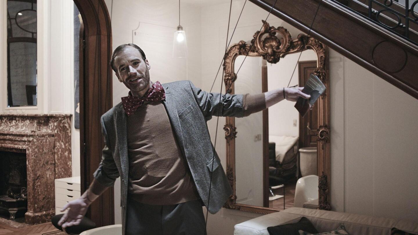 A man poses with strings attached to his wrists and arms. | "Professor T: Dead Girls Don't Sing"