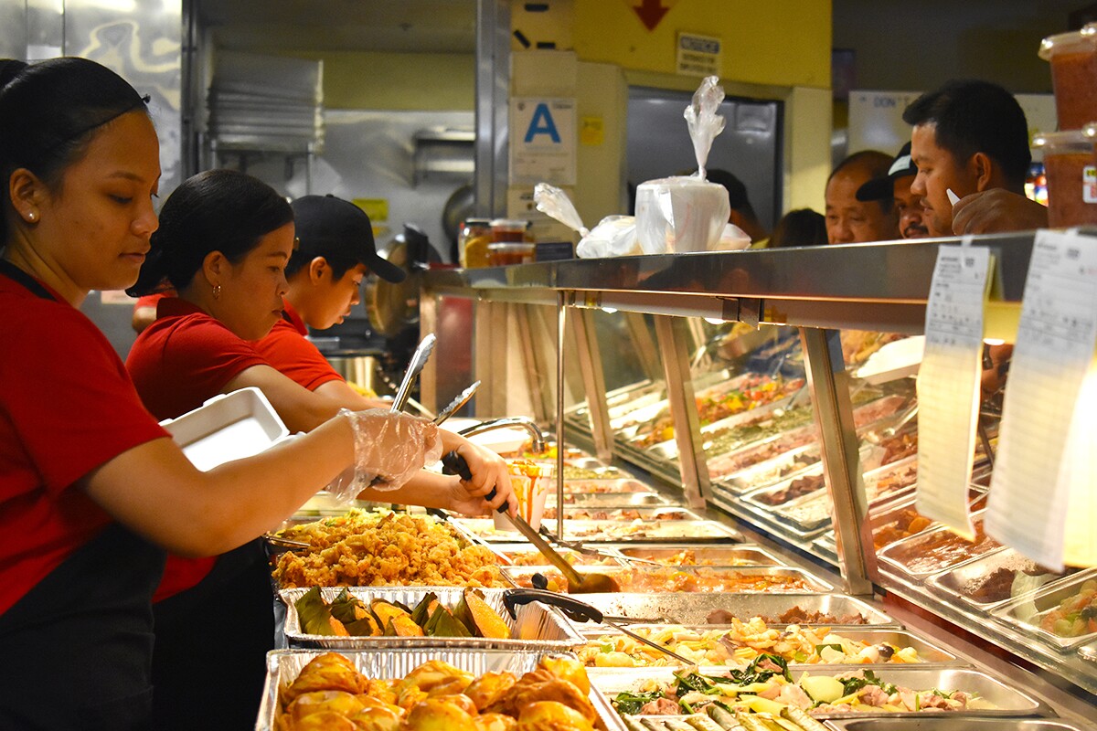 Arko Foods Market's workers serving customers in the turo-turo section. | Jacqueline Lee