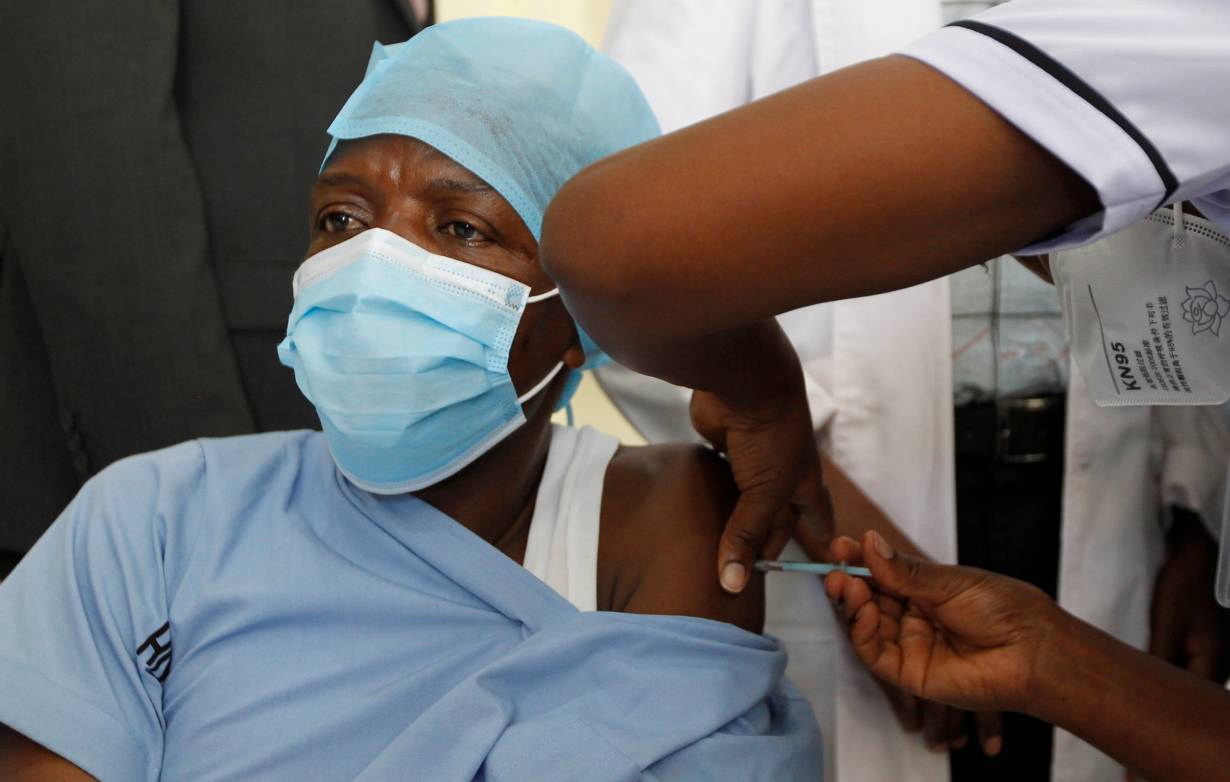 A health worker receives the AstraZeneca/Oxford vaccine under the COVAX scheme against coronavirus disease (COVID-19) at the Kenyatta National Hospital in Nairobi, Kenya March 5, 2021.