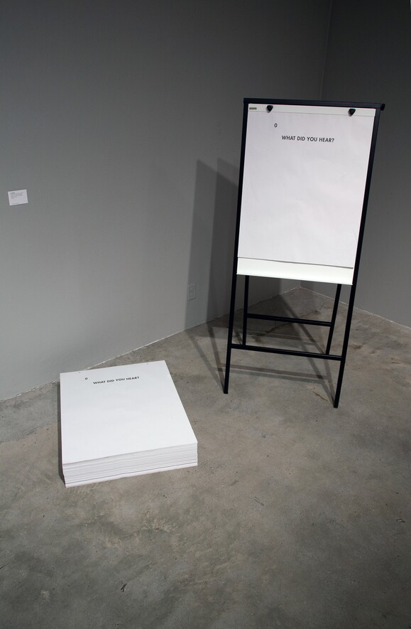 Ultra-red, "What did you hear?" (2011) Description: installation view, offset print flip-chart tablets, 50 sheets, 27" x 34", unlimited edition. Los Angeles Municipal Art Gallery. | Photograph by Patrick Hebert, courtesy Ultra-red.