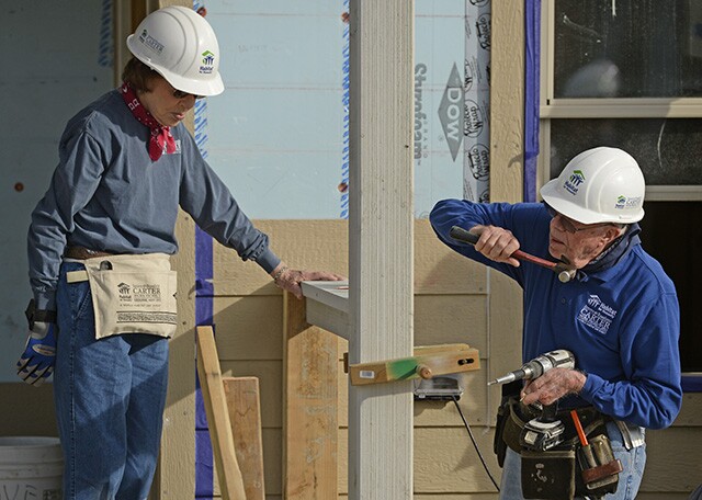 Rosalynn Carter and her husband, Jimmy, work on building a home during Habitat for Humanity's Carter Work Project event in Denver, 2013. | RJ Sangosti/Getty Images
