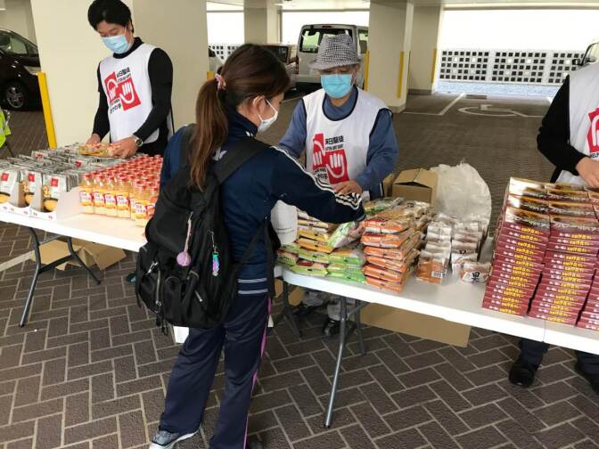 Volunteers handle food donations in Tokyo, Japan.
