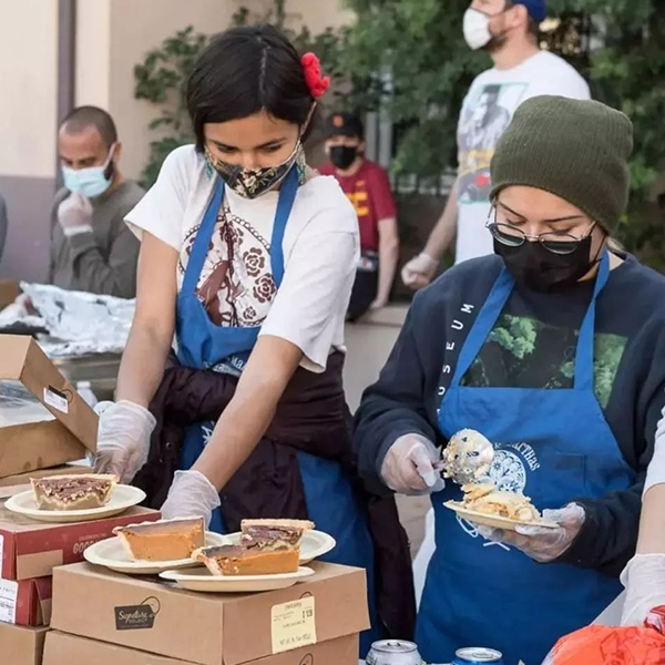 Hollywood Food Coalition volunteers prepare plates of pies.