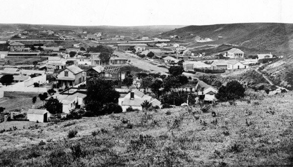 This 1869 view of Los Angeles, looking south from First and Broadway, shows an undeveloped Bunker Hill flanking the the growing city. Courtesy of the Title Insurance and Trust / C.C. Pierce Photography Collection, USC Libraries.