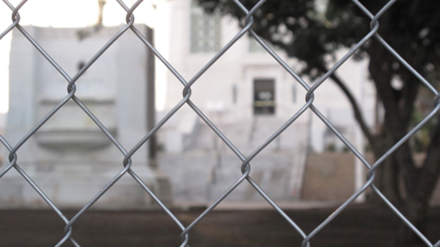Looking through the gate at the former site of Occupy L.A. | Photo by Jason Rosencrantz