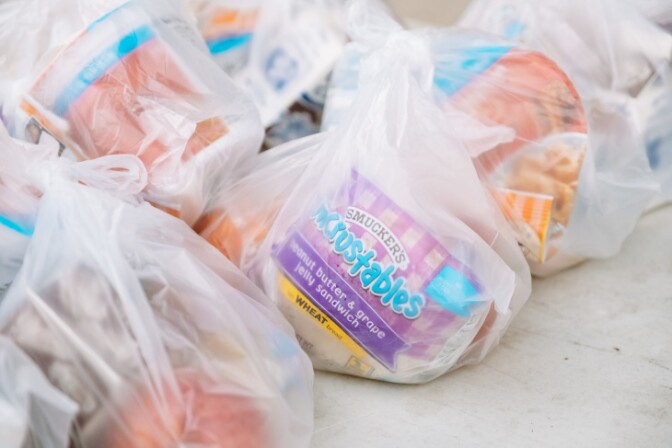 Breakfast packs with a peanut butter and jelly sandwich, cereal, fruit and milk. | Chava Sanchez/LAist