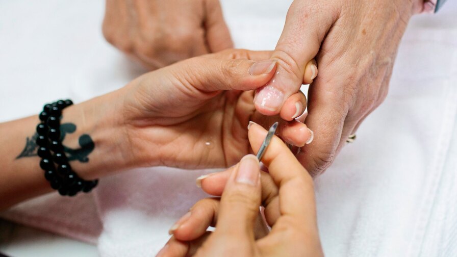 A customer at Vicky's Nail Salon receives a manicure in Alameda, Calif., Wednesday, Aug. 28, 2019. | Alison Yin for KCET