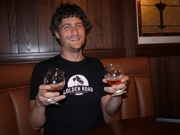 Tony Yanow holding up a glass of Aunt Sally's Pale Ale and It's Always Not Sunny in L.A.