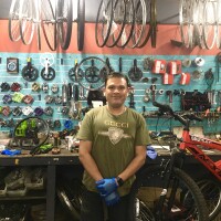 Nestor Lobo, owner of Retro Xpress Bicycles in Van Nuys, stands in front of his work station.