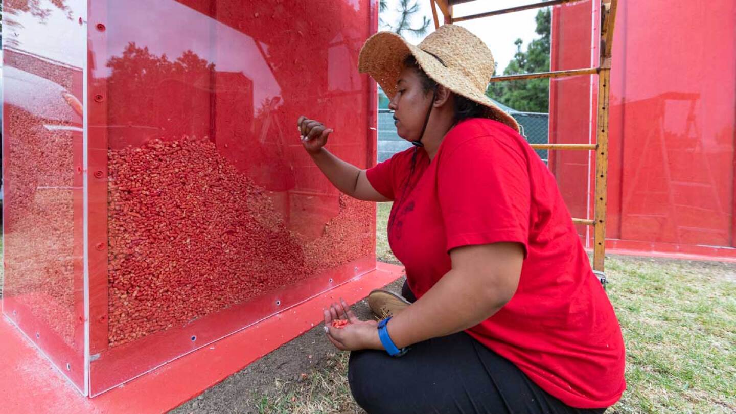 Jazmin Urrea working on "Imperishable," 8-foot tall Cheetos sculptures for Current:LA Food | Courtesy of the Department of Cultural Affairs, Los Angeles