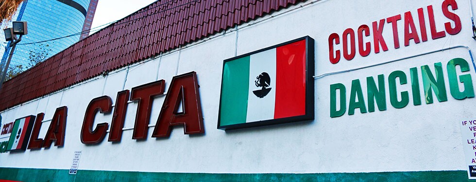 La Cita Sign with LA skyscraper in the back: Mexican flag, ":Cocktails," "Dancing" | Samanta Helou