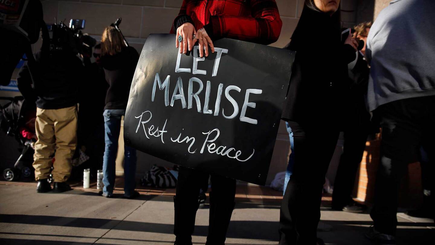 Still of protester holding sign from "62 Days." | Reel South