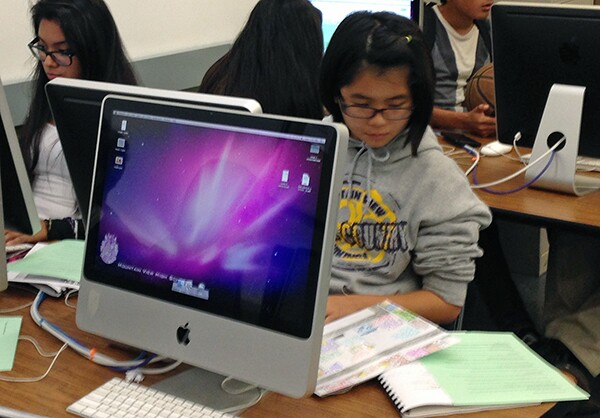 Laura uses her map to write her article.