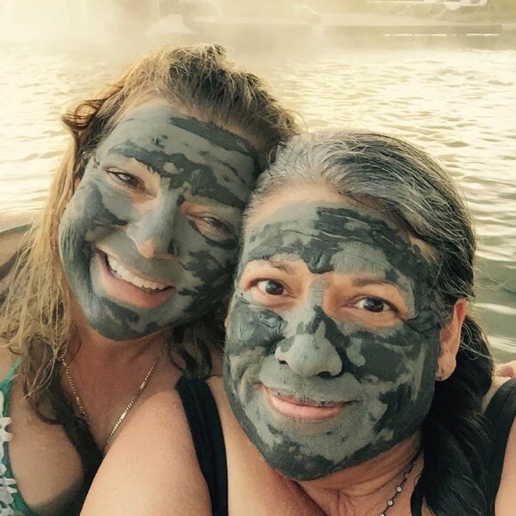 Photographer Yvonne Willis takes a selfie of herself and friend, Susanne Elena, demonstrating the do-it-yourself mud treatments at Franklin Pond.