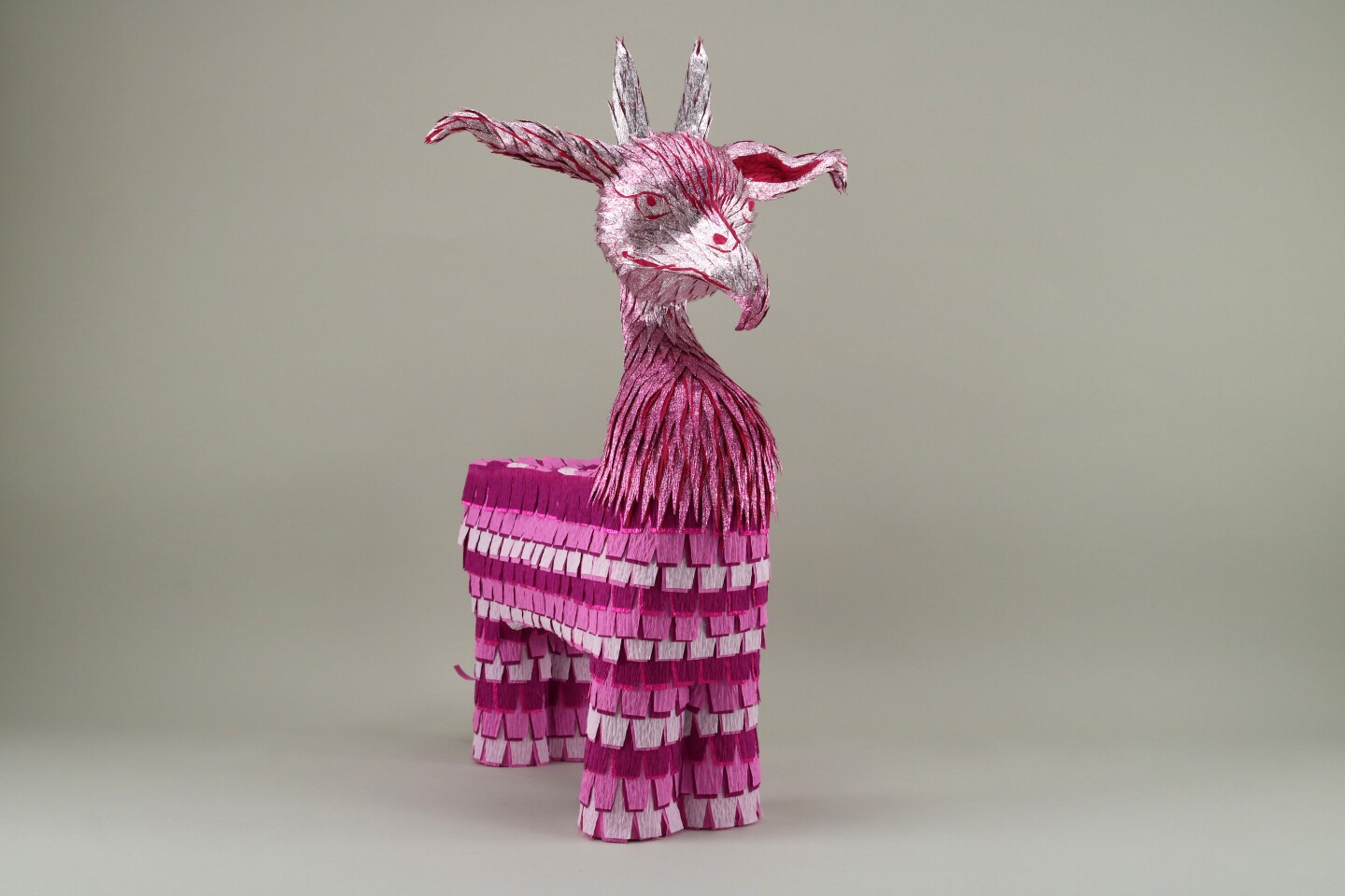 A pink horse mixed with a bird-like animal is depicted in this piñata.