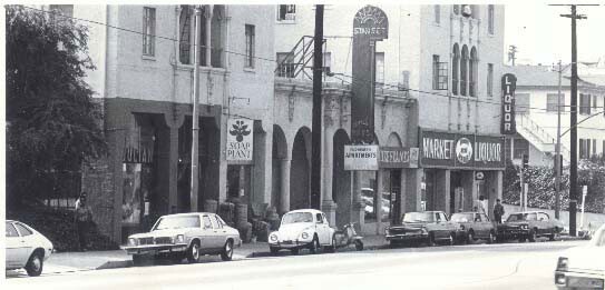 A street view of Sunset Boulevard, the first Soap Plant location. Cars are parked along the street.