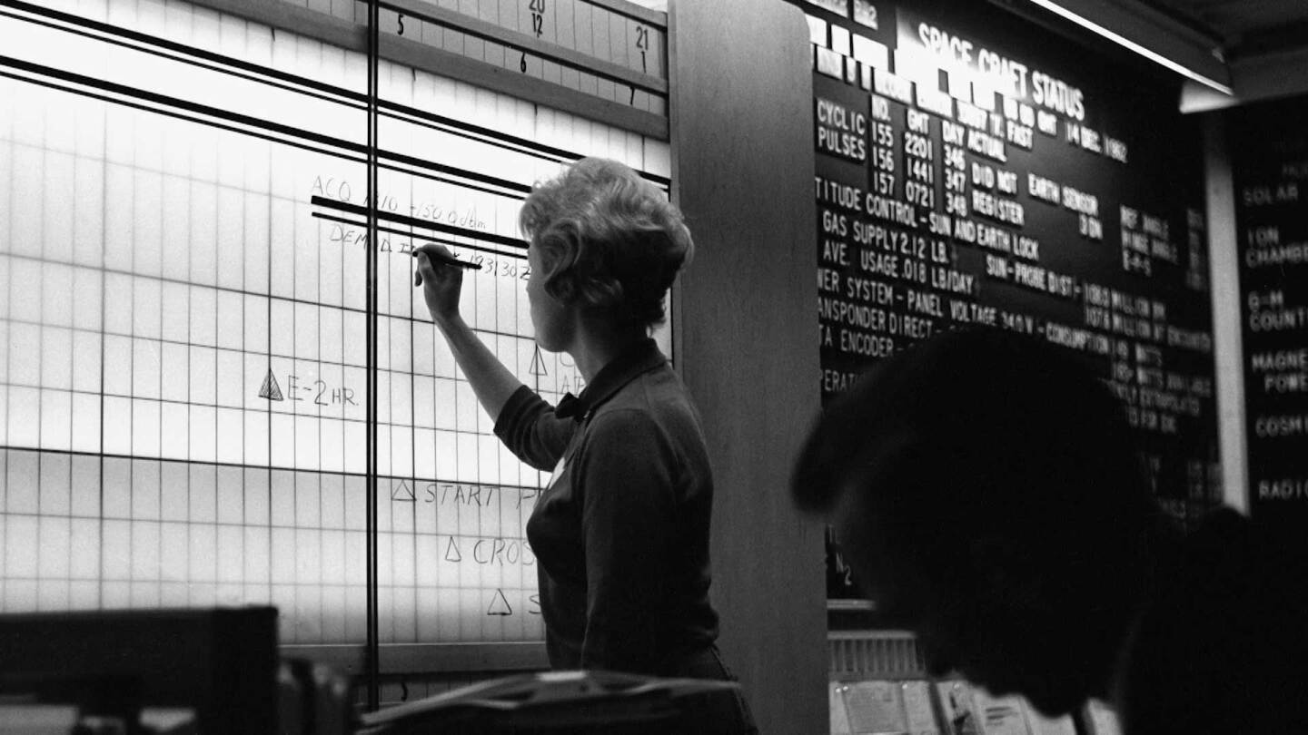 Sue Finley making calculations on the board. | Still from “Blue Sky Metropolis” Episode 4