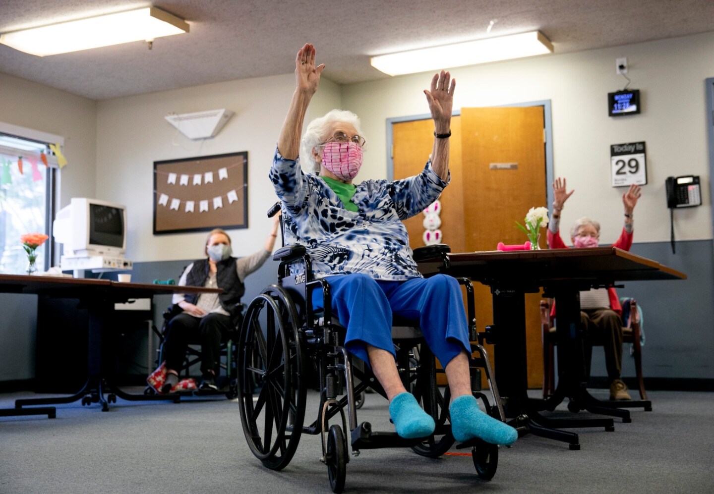 Betty Carter, center, participates in group exercise with others from her cohort at Lincoln Glen Skilled Nursing Facility.