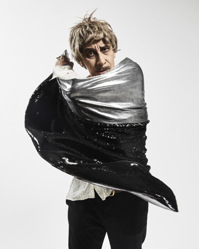 Kid Congo Powers wrapped in a glittery silver cape