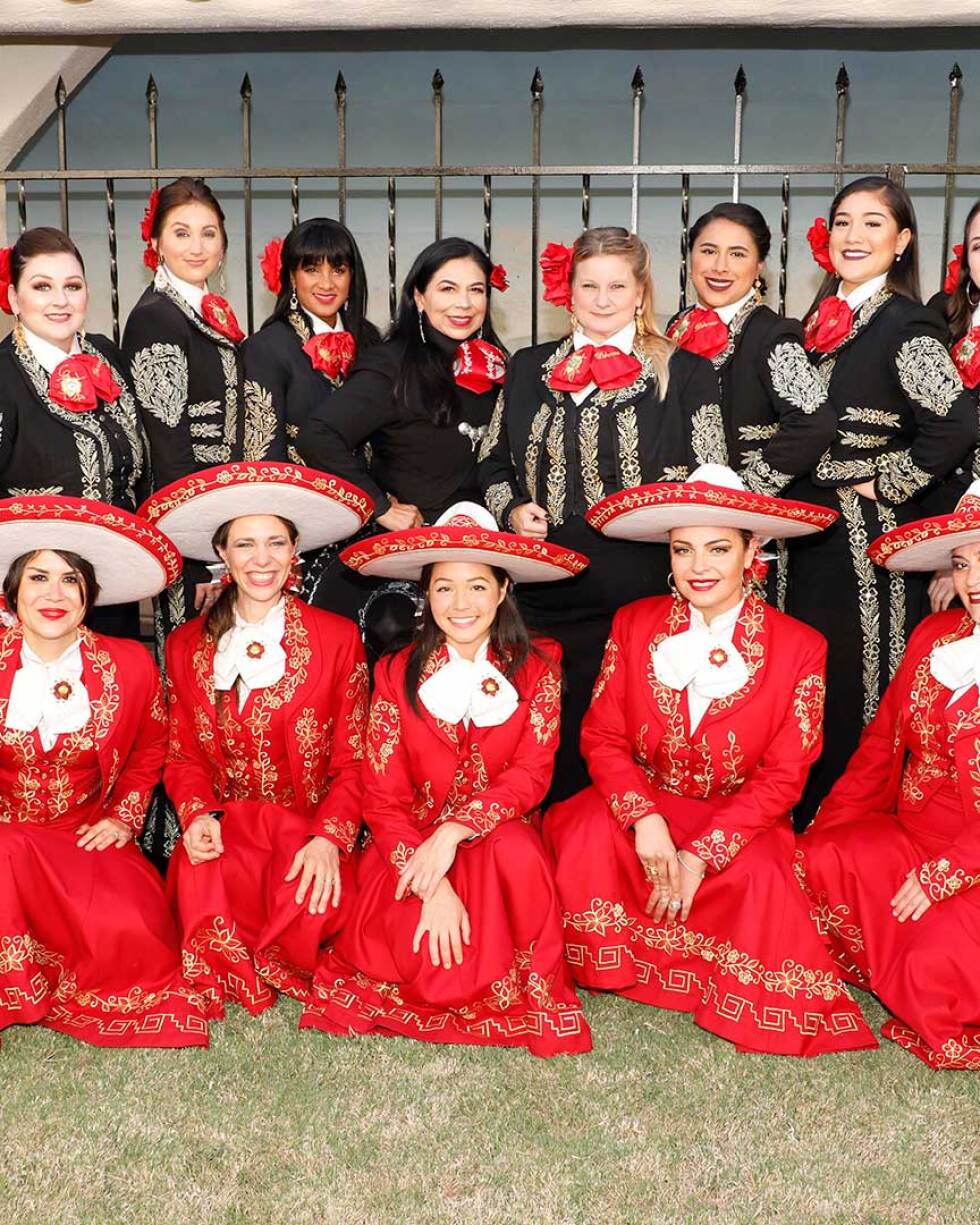 Mariachi Divas de Cindy Shea (top row), Leonor Xochitl Perez, Ph.D. (top row, sixth, clockwise) and Las Adelitas (bottom row, in red) in London at the International Mariachi Women’s Festival, July 21, 2018. | Eddie Sakaki Photographer