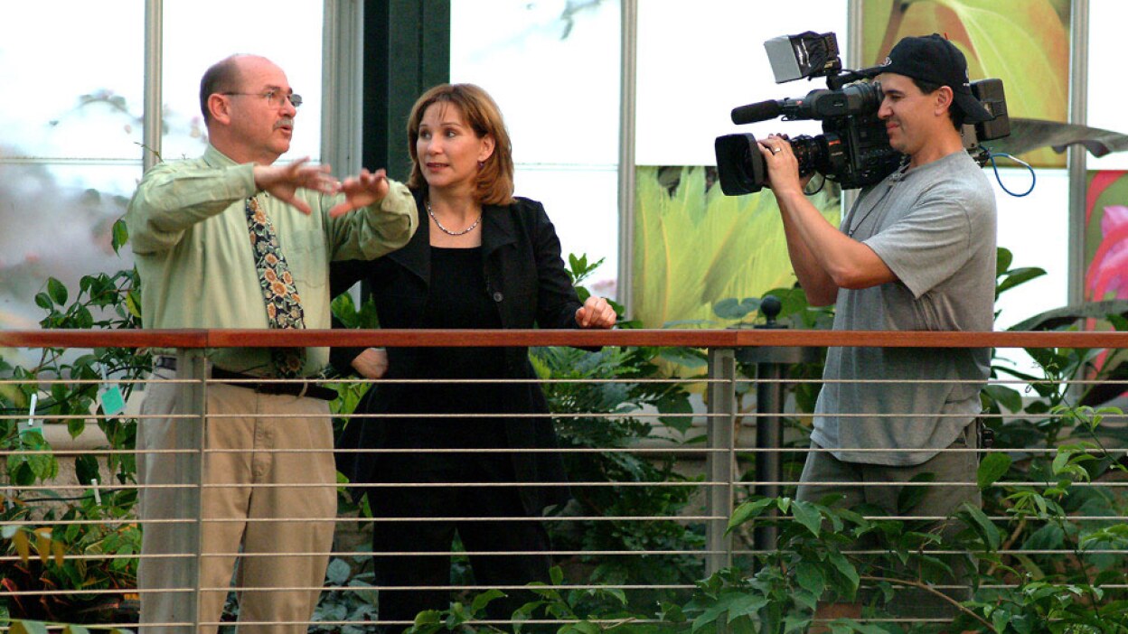 Val Zavala Outside with a Camera Operator and an Interview Subject