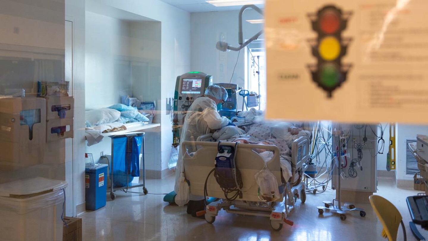 Nurse Yvonne Yaory checks on a coronavirus patient who is connected to a ventilator. | Heidi de Marco/California Healthline