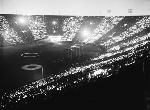 Spectators light matches as part of a July 4, 1958 celebration at the Los Angeles Memorial Coliseum