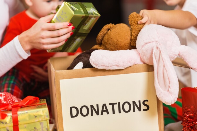 Family donating gifts and toys to charity for holiday