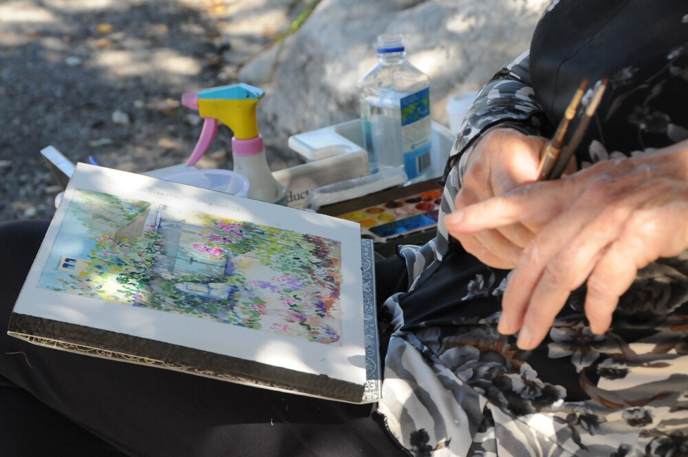 Artist and California Art Club board member, Gayle Garner Roski, paints flowers "en plein air" around La Casita for "Paint On" October 12th