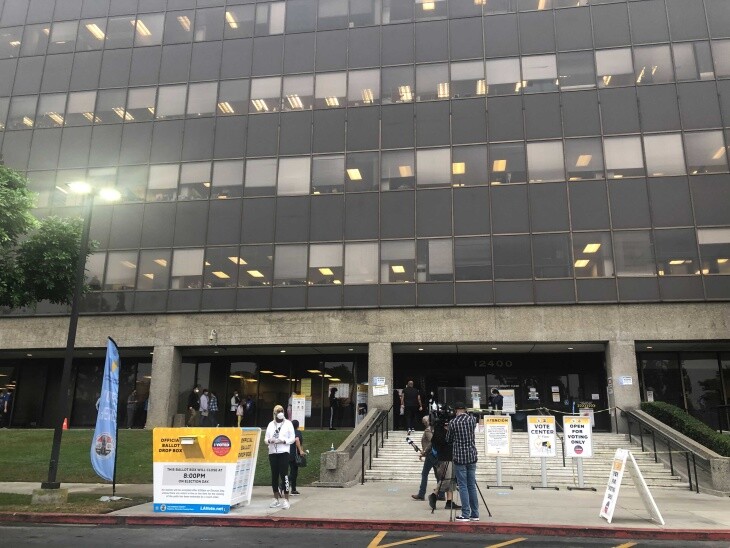 Voters mill about at the Los Angeles Registrar's office in Norwalk, waiting to cast their ballots. | Carla Javier/LAist