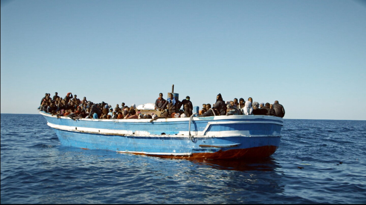 A wooden boat overloaded with refugees from Libya, in the documentary “Drowning Letters” by Paula Palacios. | Still courtesy of Paula Palacios