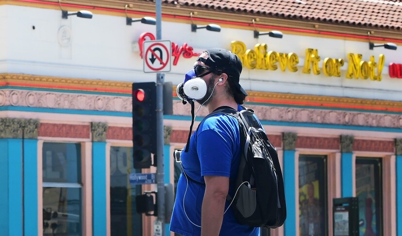 A pedestrian in a facemask walks in Hollywood, California on April 23. | Frederic J. Brown/AFP via Getty Images