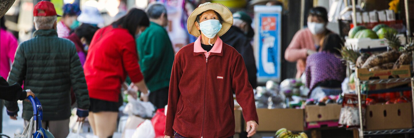 Shoppers following COVID-19 protocol, in face coverings at a street market in Chinatown on Tuesday, Nov. 10, 2020 in Los Angeles. | Irfan Khan / Los Angeles Times via Getty Images