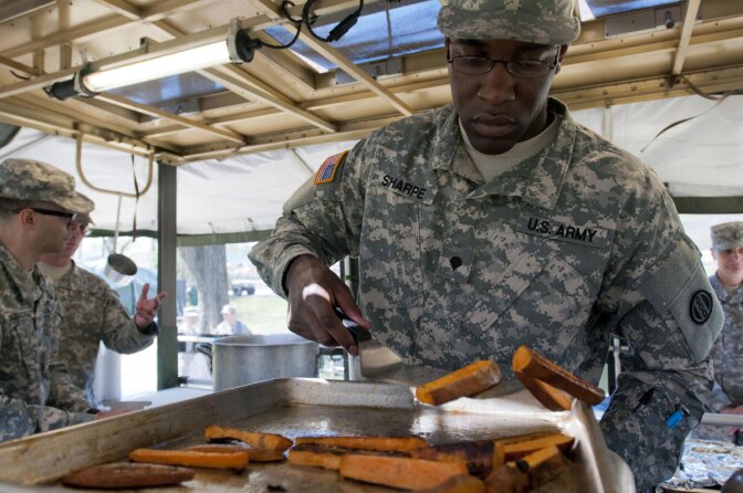 Spc. Jordan Sharpe, a food service specialist with the 733rd Transportation Company, flips sweet potatoes after being cooked | Photo by Staff Sgt. Dalton Smith/Army Reserve News Articles