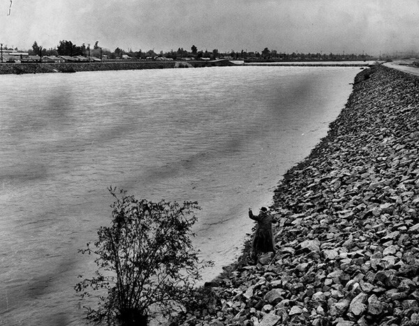An elderly man fishes off the banks of the San Gabriel River, November 23, 1965 | Courtesy of the Los Angeles Public Library